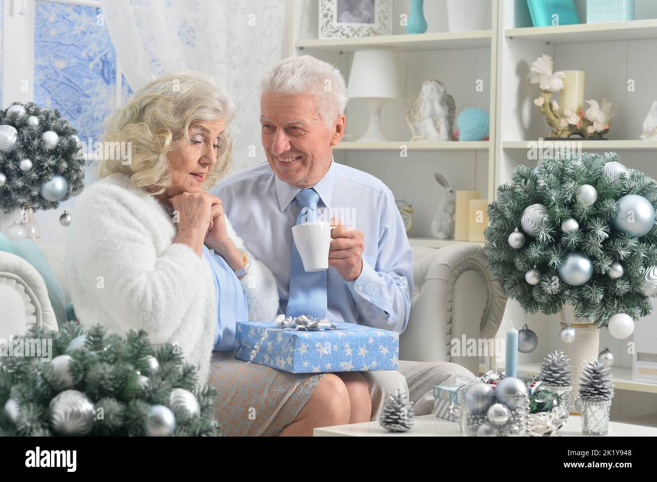 Elderly couple in a room with New Year's decor Stock Photo