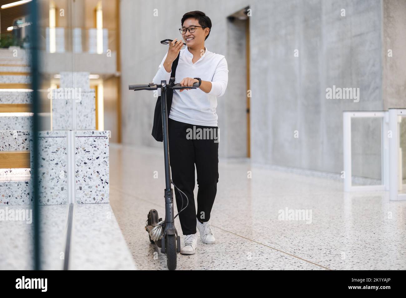 Young man with an electric scooter Stock Photo