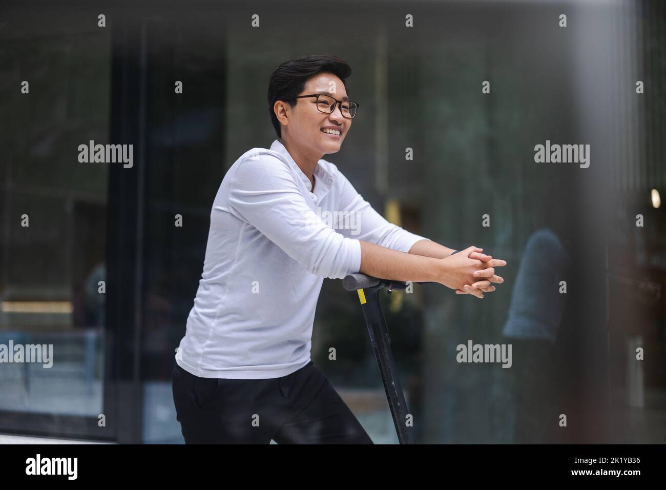 Young man with an electric scooter Stock Photo