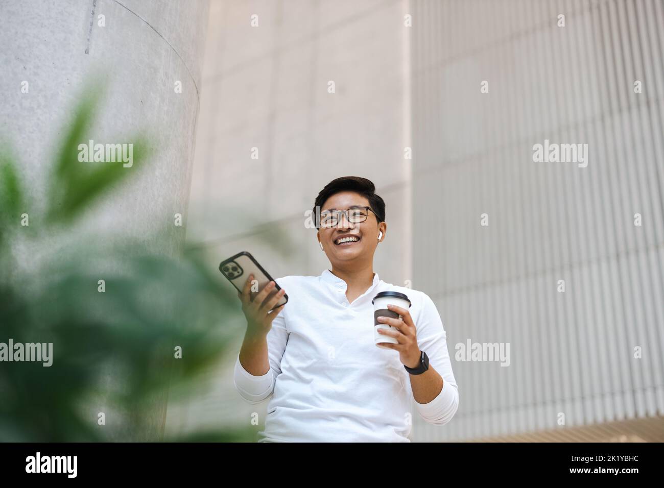 Smiling young man using mobile phone Stock Photo