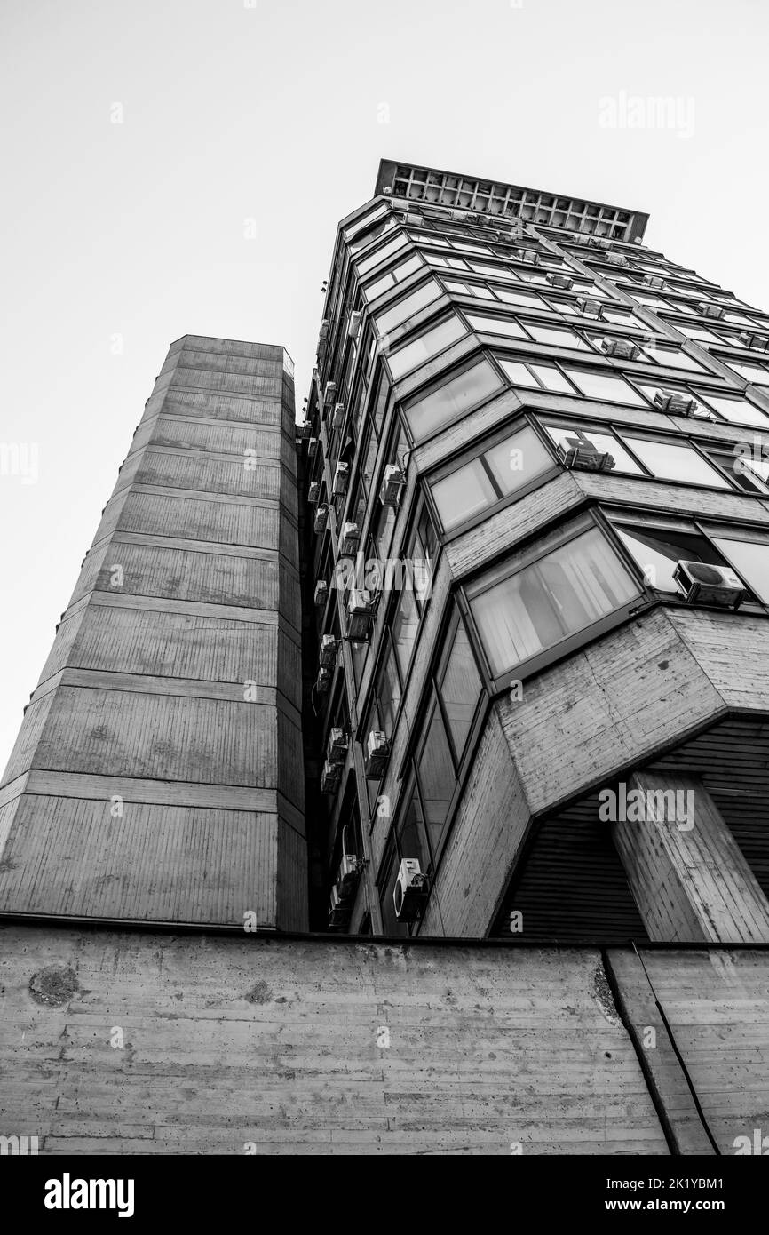 A high rise modern tower building in the city of Skopje, capital of North Macedonia, ex Yugoslavia. Dull and grey building, apartment block. Stock Photo