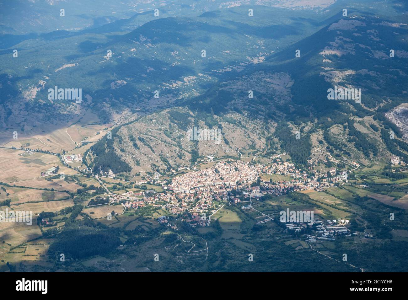 aerial shot, from a small plane, of Rocca di Mezzo village in Ovindoli upland, shot in bright summer light from west, Apennines, L'Aquila, Abruzzo,  I Stock Photo