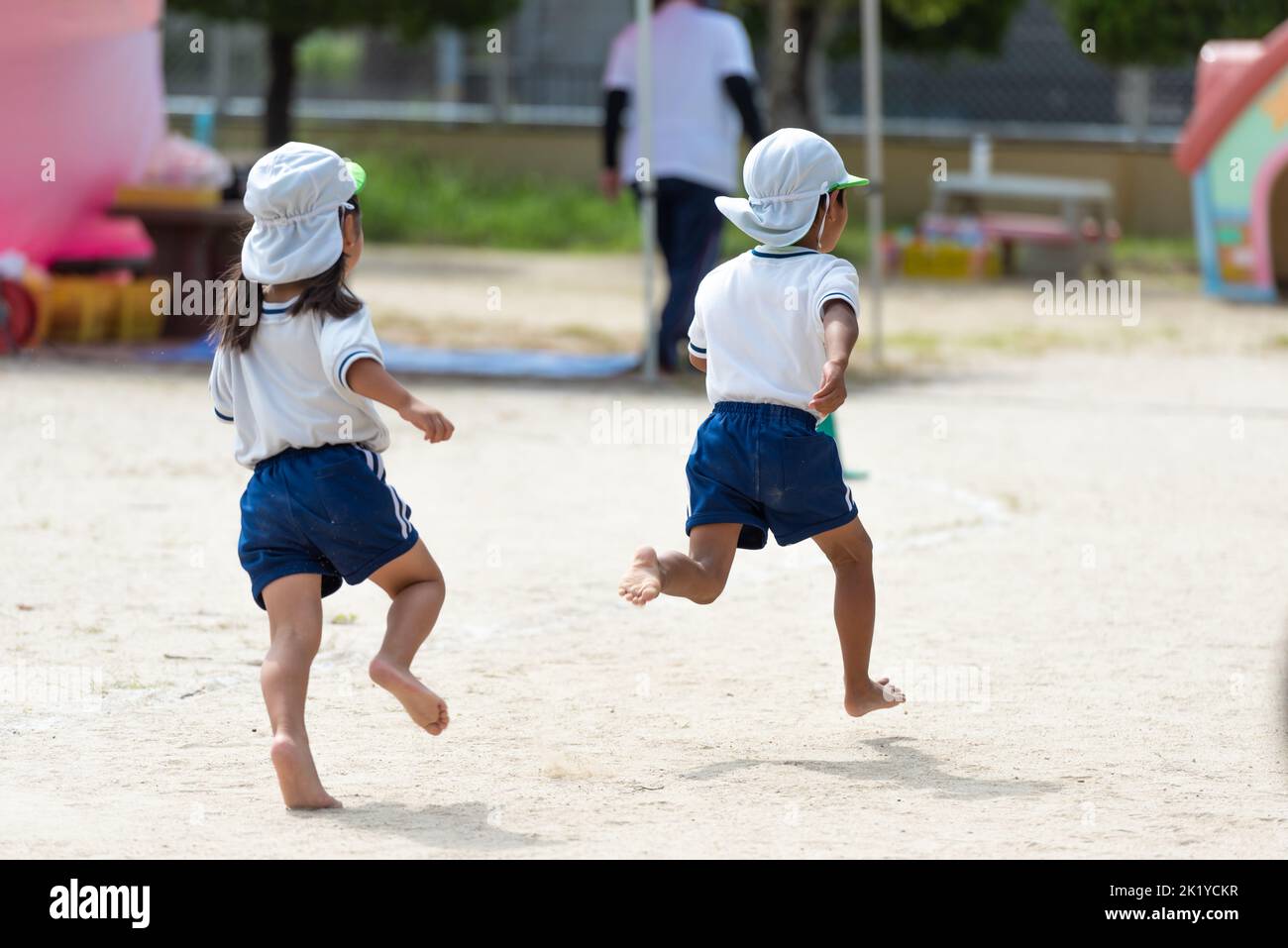 Children running on the ground during sports day at a Japanese