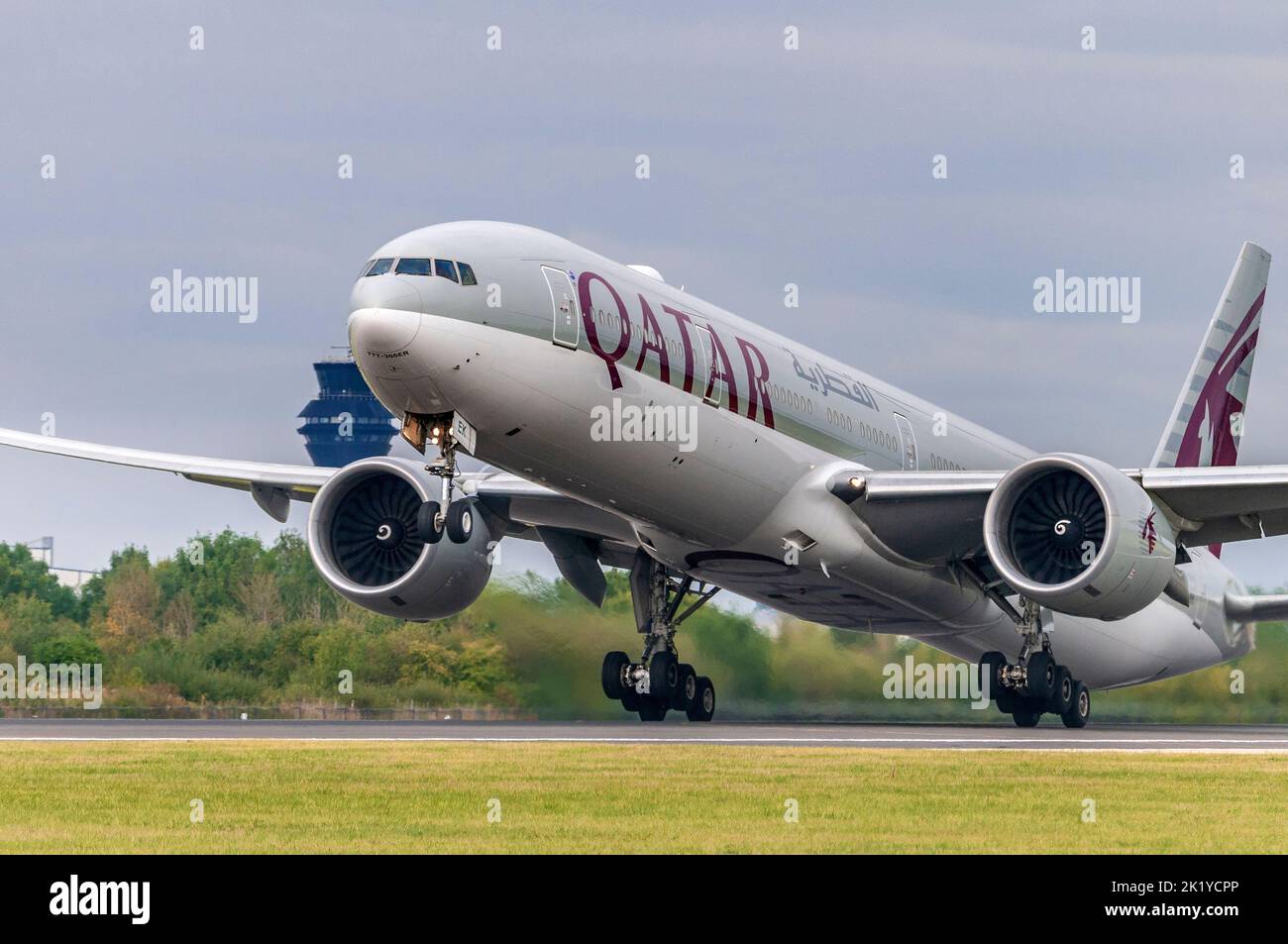 Qatar Airways Boeing 777-300/ER registration A7-BEK takes off at Manchester airport. Stock Photo