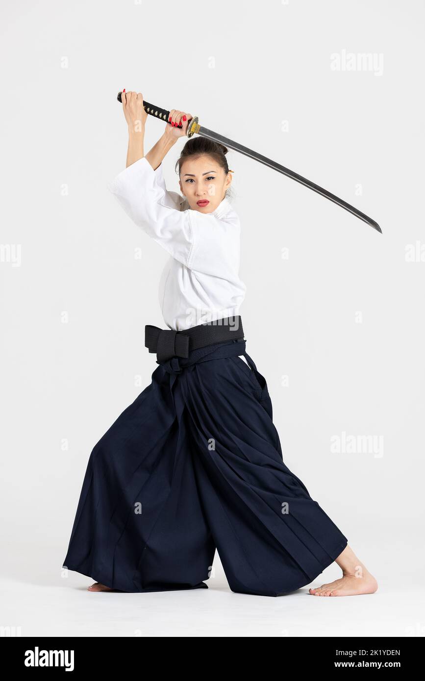 Aikido master woman in traditional samurai hakama kimono with black