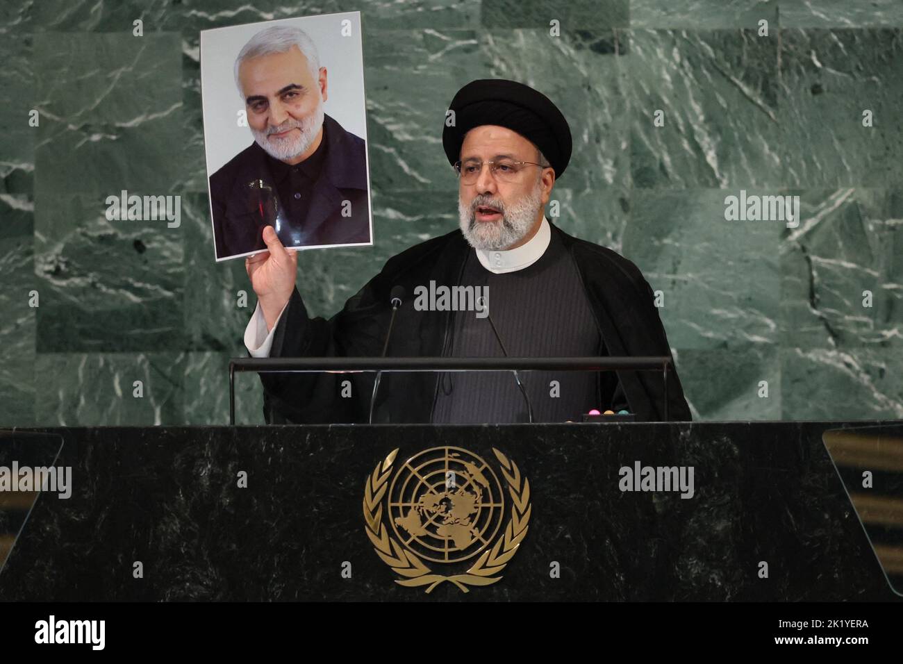Iran's President Ebrahim Raisi holds up a picture of Quds Force Commander General Qassem Soleimani, who was killed in a U.S. attack, as he addresses the 77th Session of the United Nations General Assembly at U.N. Headquarters in New York City, U.S., September 21, 2022. REUTERS/Brendan Mcdermid Stock Photo