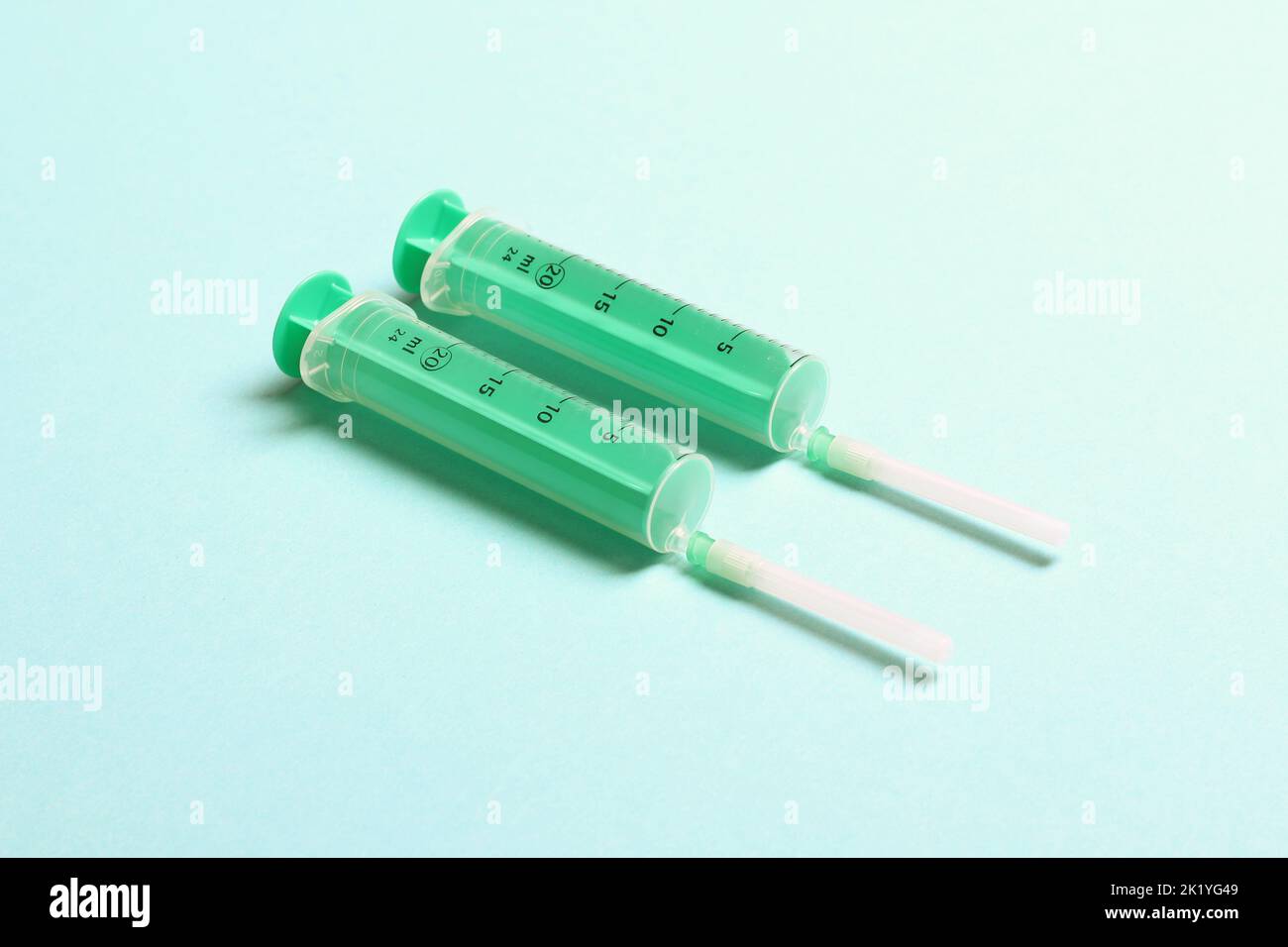 Scroll Syringe Top view of syringes in a row for medical injection on colorful ...