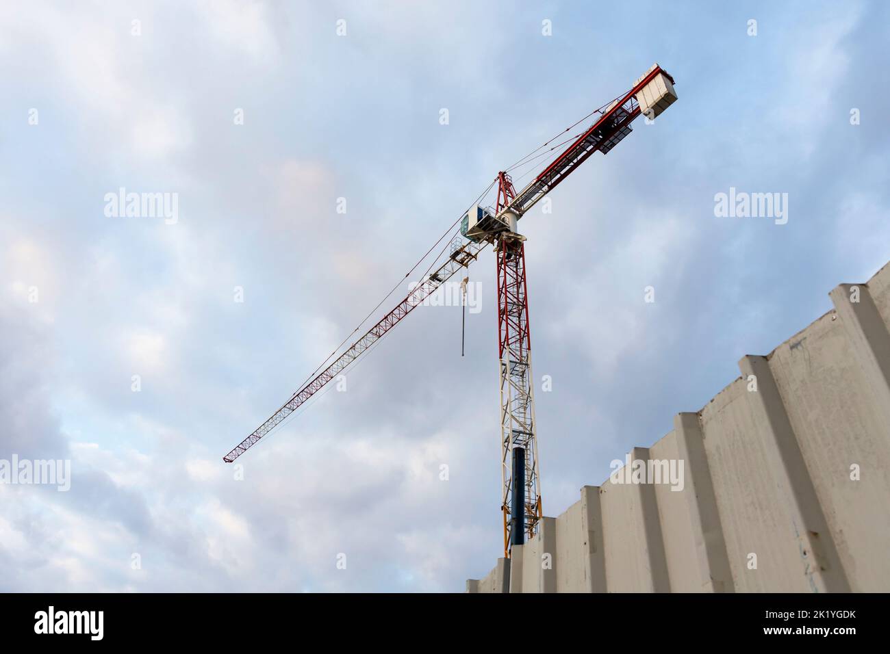 Construction crane with cloudy sky background Stock Photo - Alamy