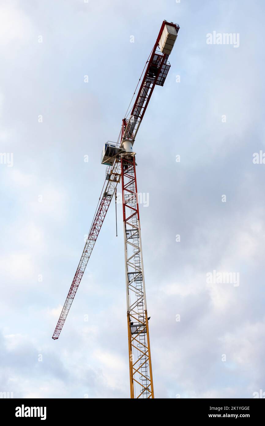 Construction crane with cloudy sky background Stock Photo - Alamy