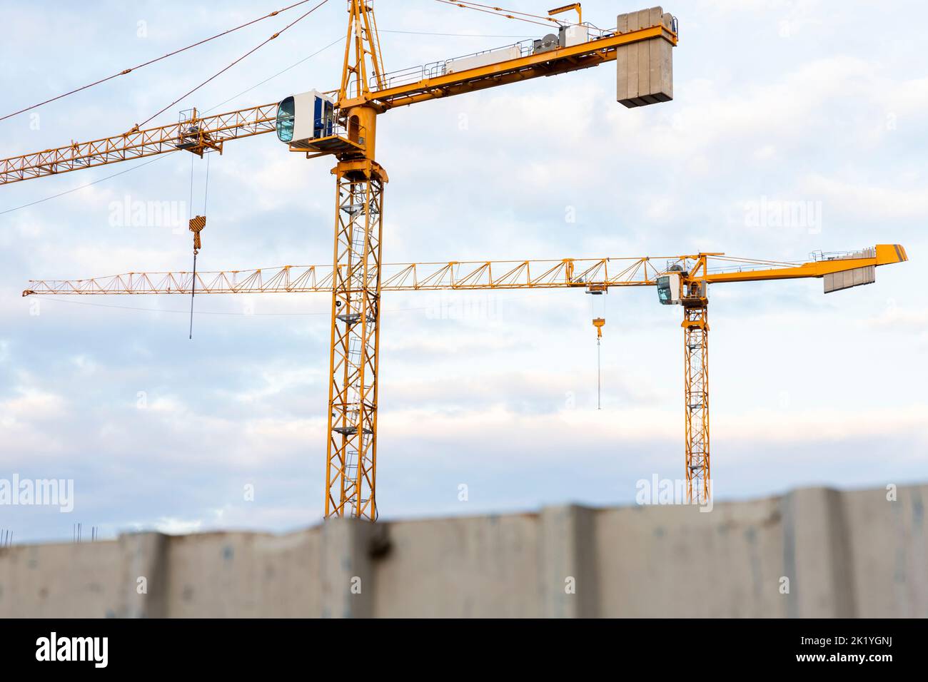 Construction crane with cloudy sky background Stock Photo - Alamy