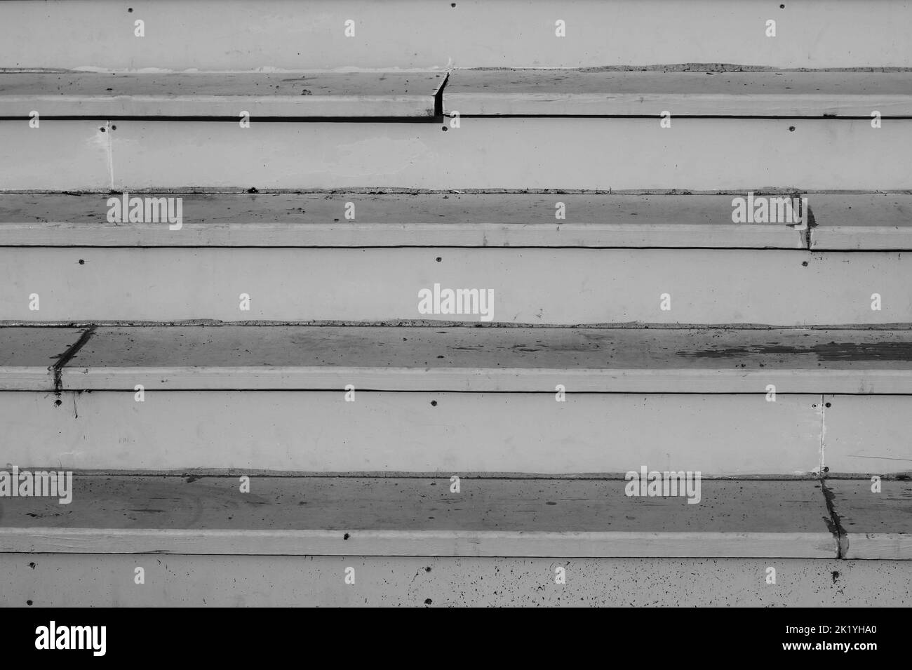 Vintage worn wooden stairs made of planks and nails in black and white