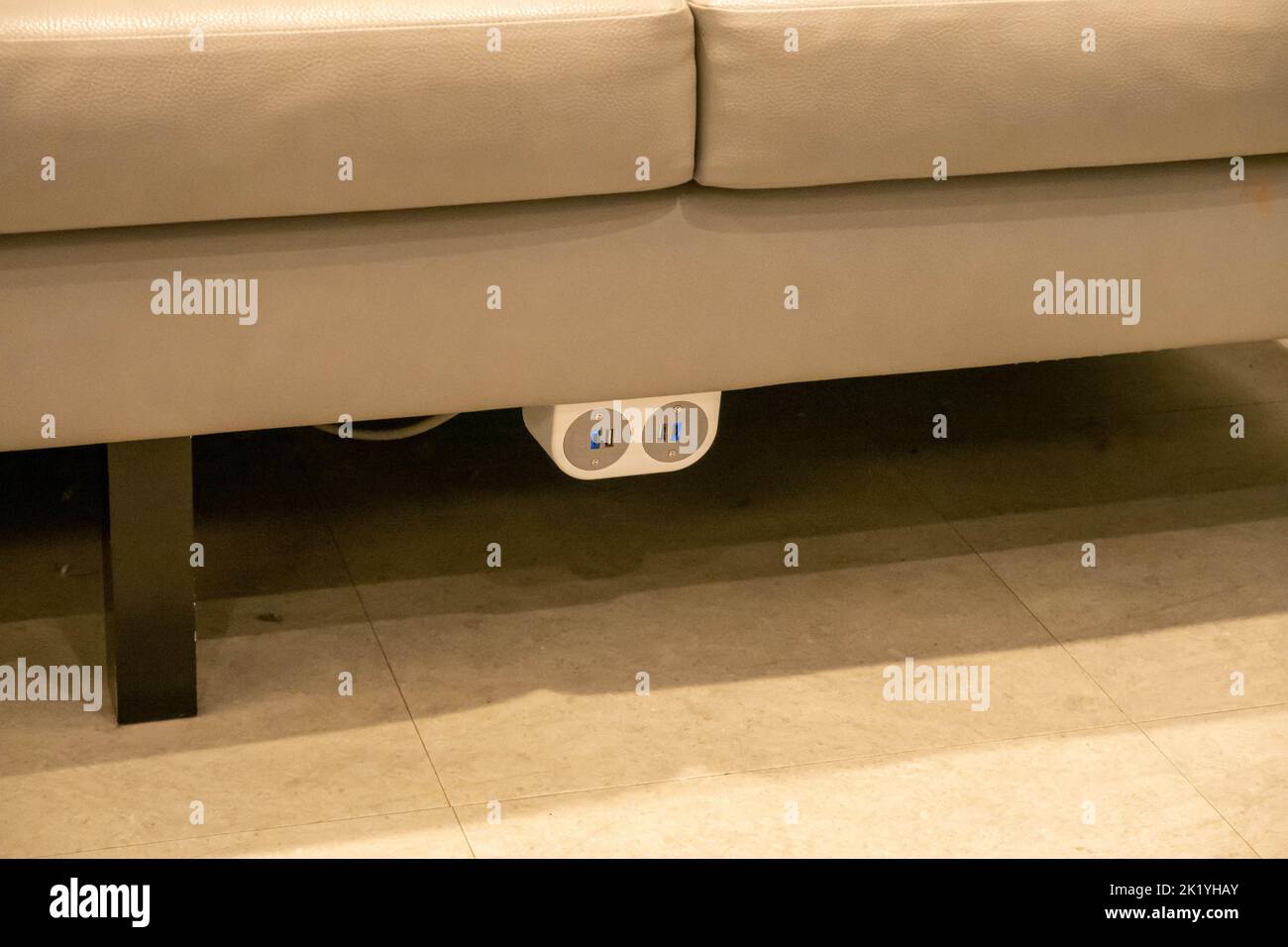 A free phone charging sockets on a sofa in a clothes shop in Norwich England Stock Photo