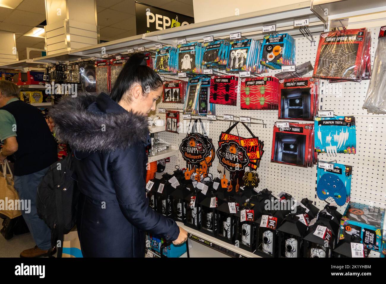 Lady shopper looking at the Halloween items in a cheap superstore in