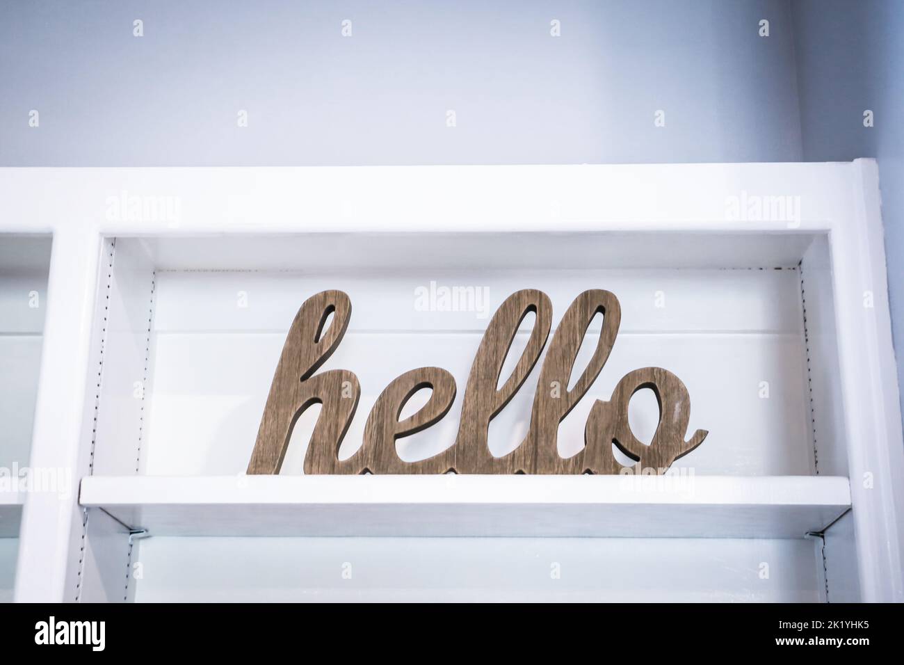 A hellow welcome sign to a house, open house or business sitting on a white shelf. Stock Photo