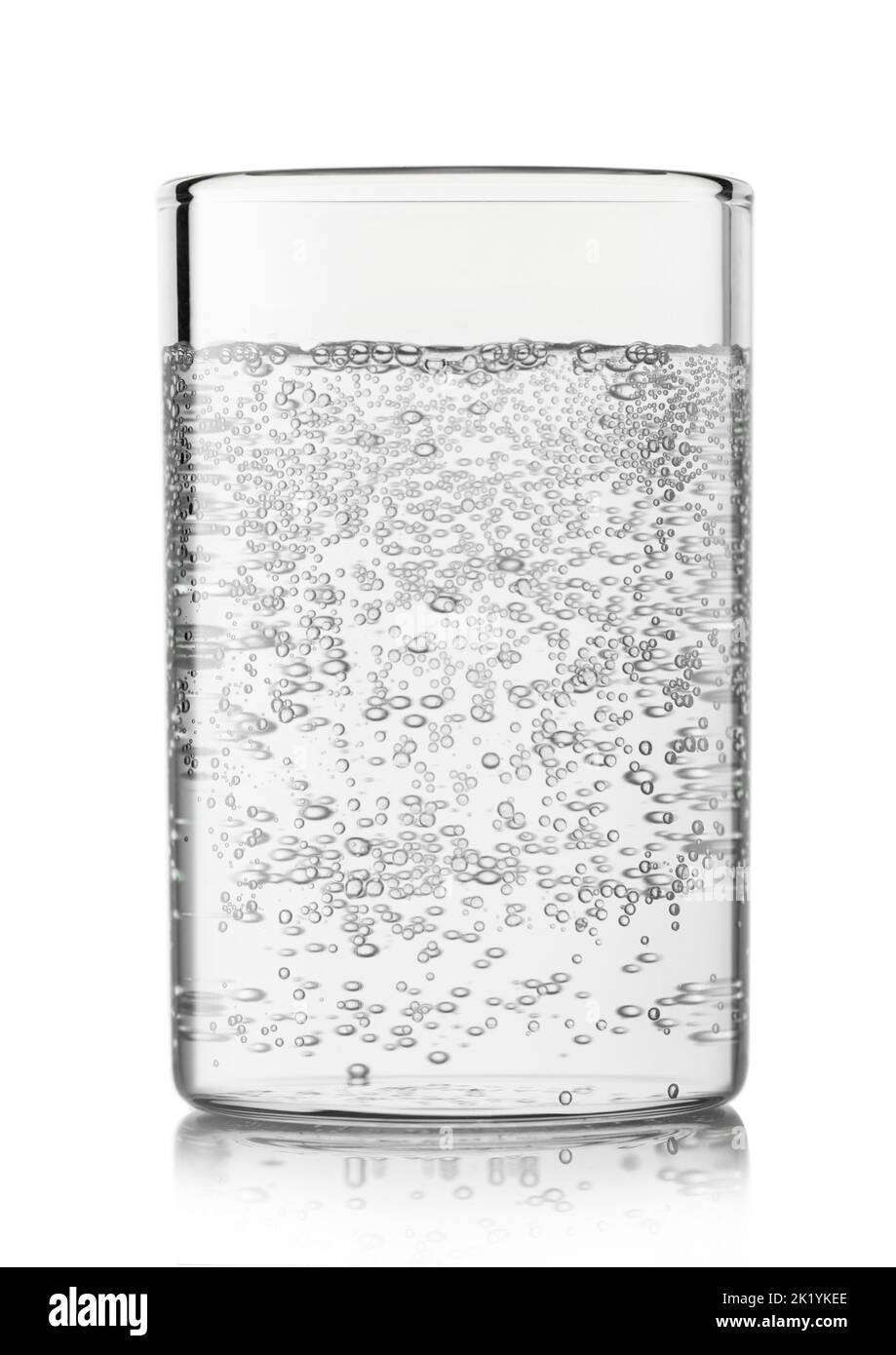 Mineral sparkling water with bubbles in highball glass on white background. Stock Photo
