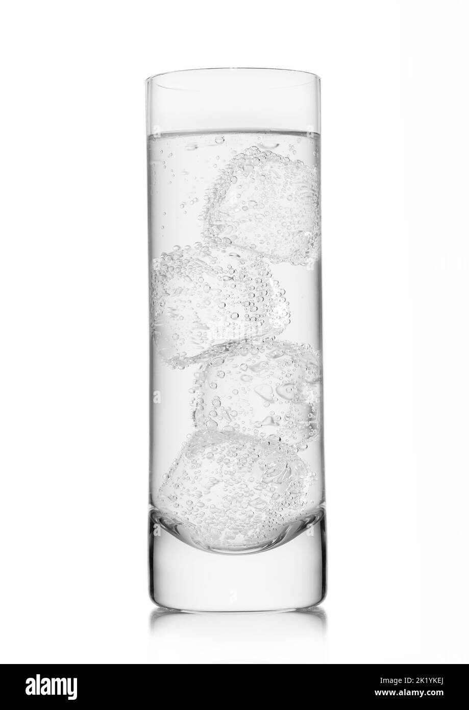 Mineral sparkling water lemonade with ice cubes in highball glass on white. Stock Photo