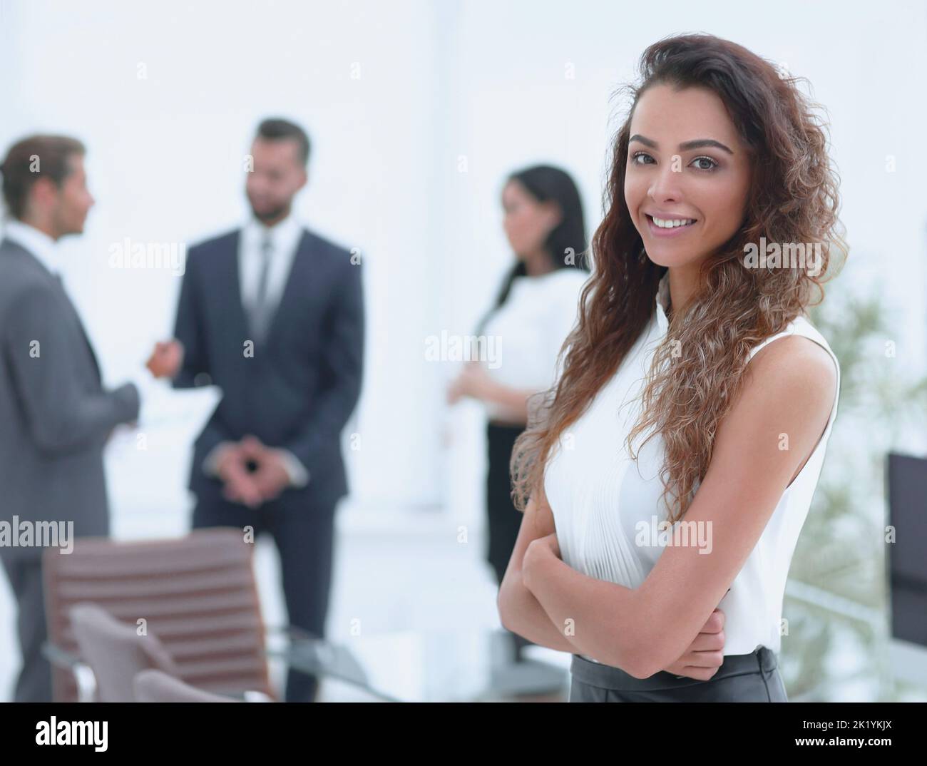 beautiful woman on the background of business people Stock Photo - Alamy