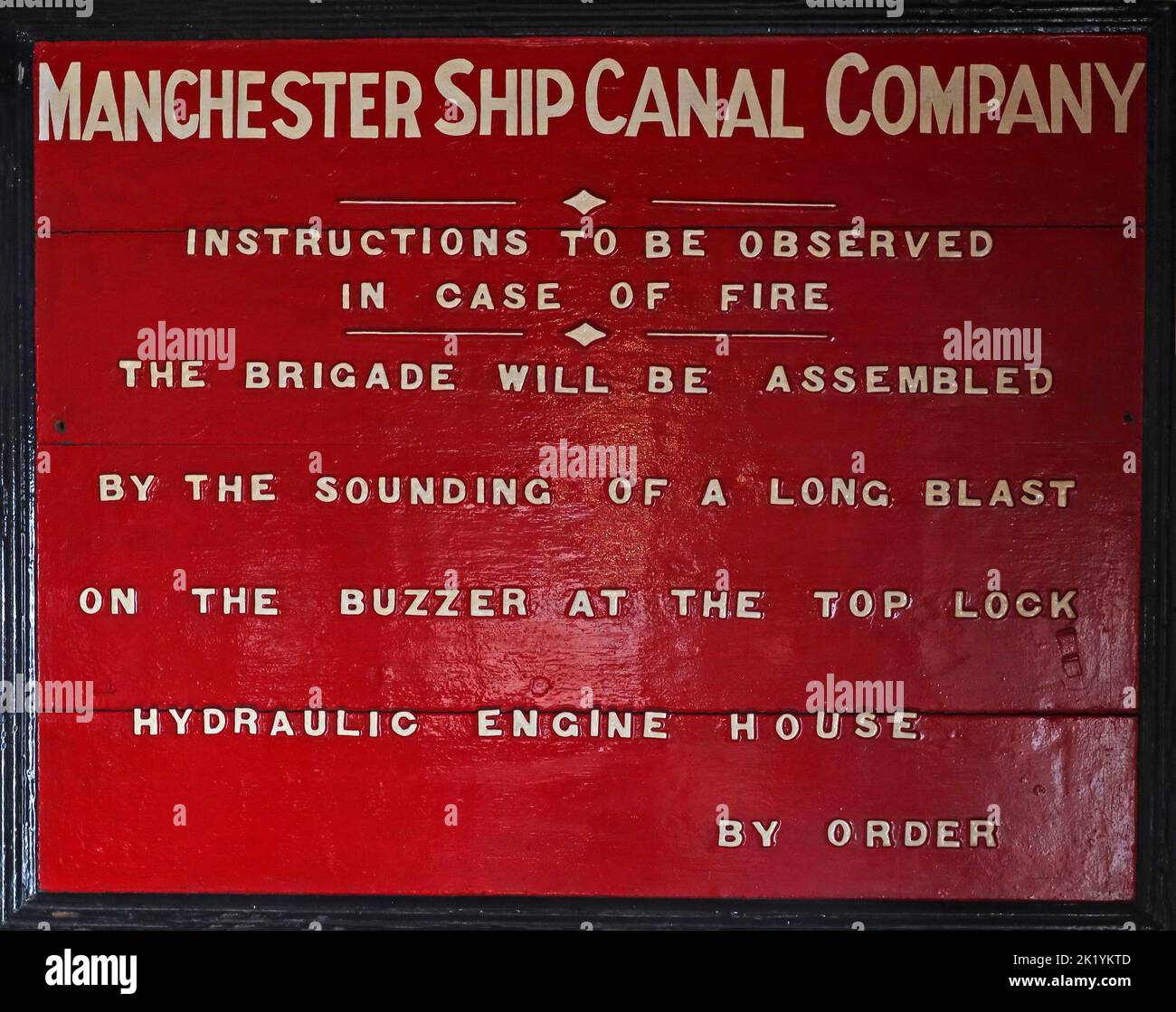 Red historic sign, MSCC, Manchester Ship Canal Company, fire instructions Stock Photo