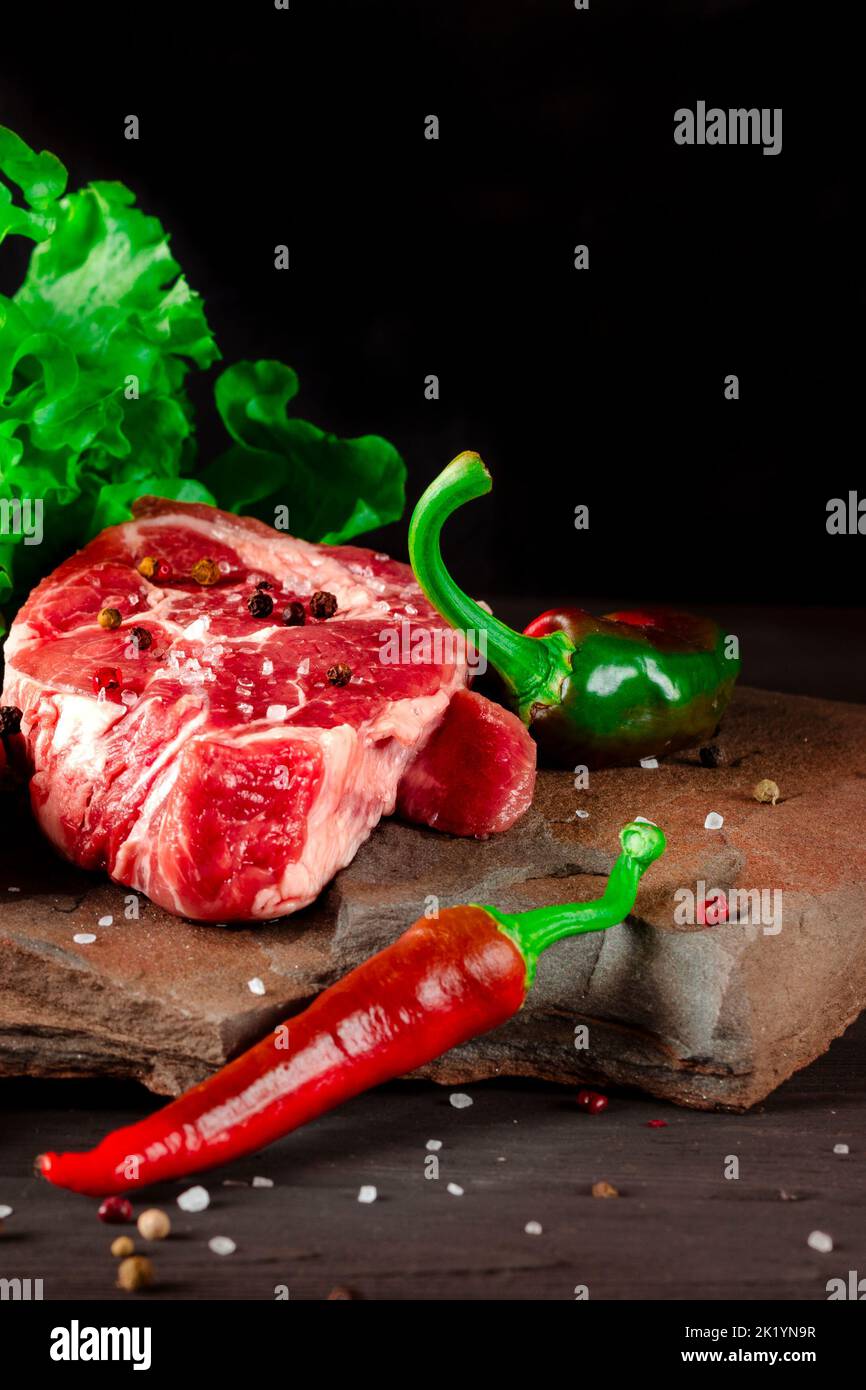 Meat set. Raw juicy pork steaks and fresh vegetables before cooking