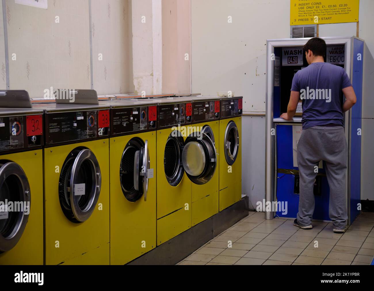 Man using the laundrette in Pimlico London Stock Photo