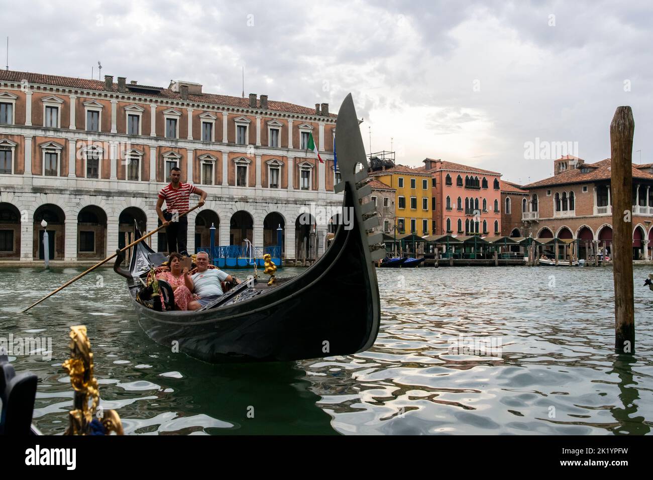 Tourists having a 'gondola' trip accross the channels in Venice, Italy. Stock Photo