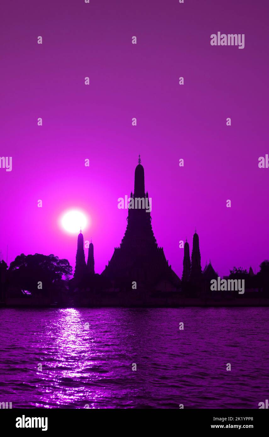 Pop Art Style Vibrant Purple Colored Wat Arun or The Temple of Dawn with Bright Sun on Chao Phraya Riverbank, Bangkok, Thailand Stock Photo