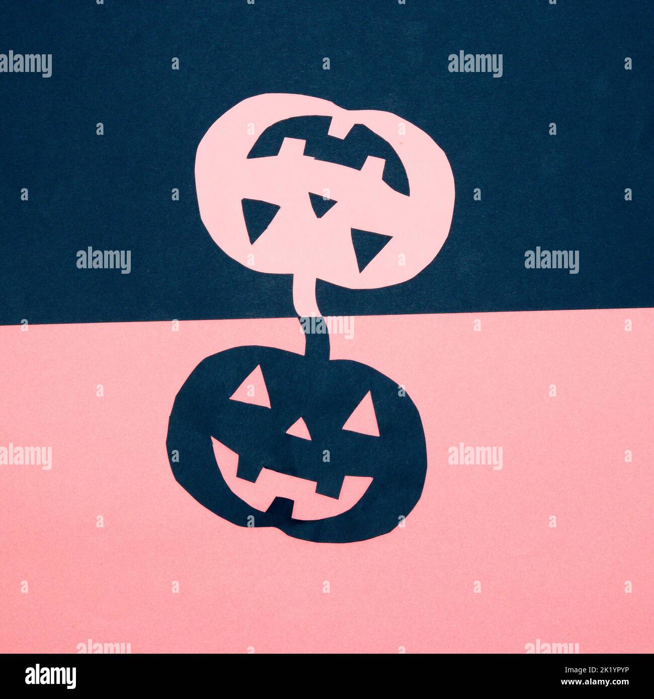 blue and pink background with blue and pink paper pumpkin, creative art design, halloween minimal concept, flat lay Stock Photo