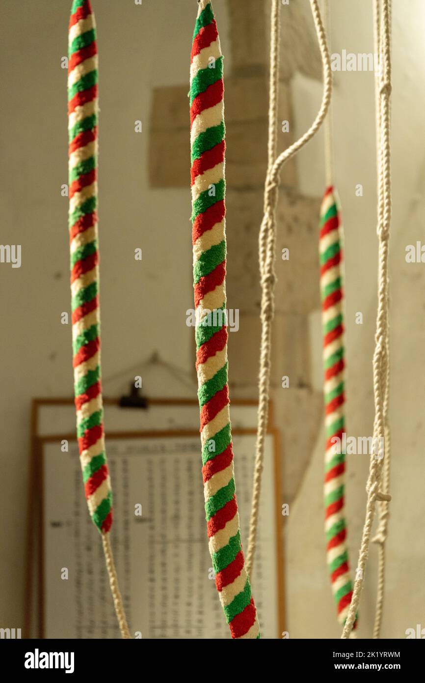 Bell ringing ropes in a church Stock Photo