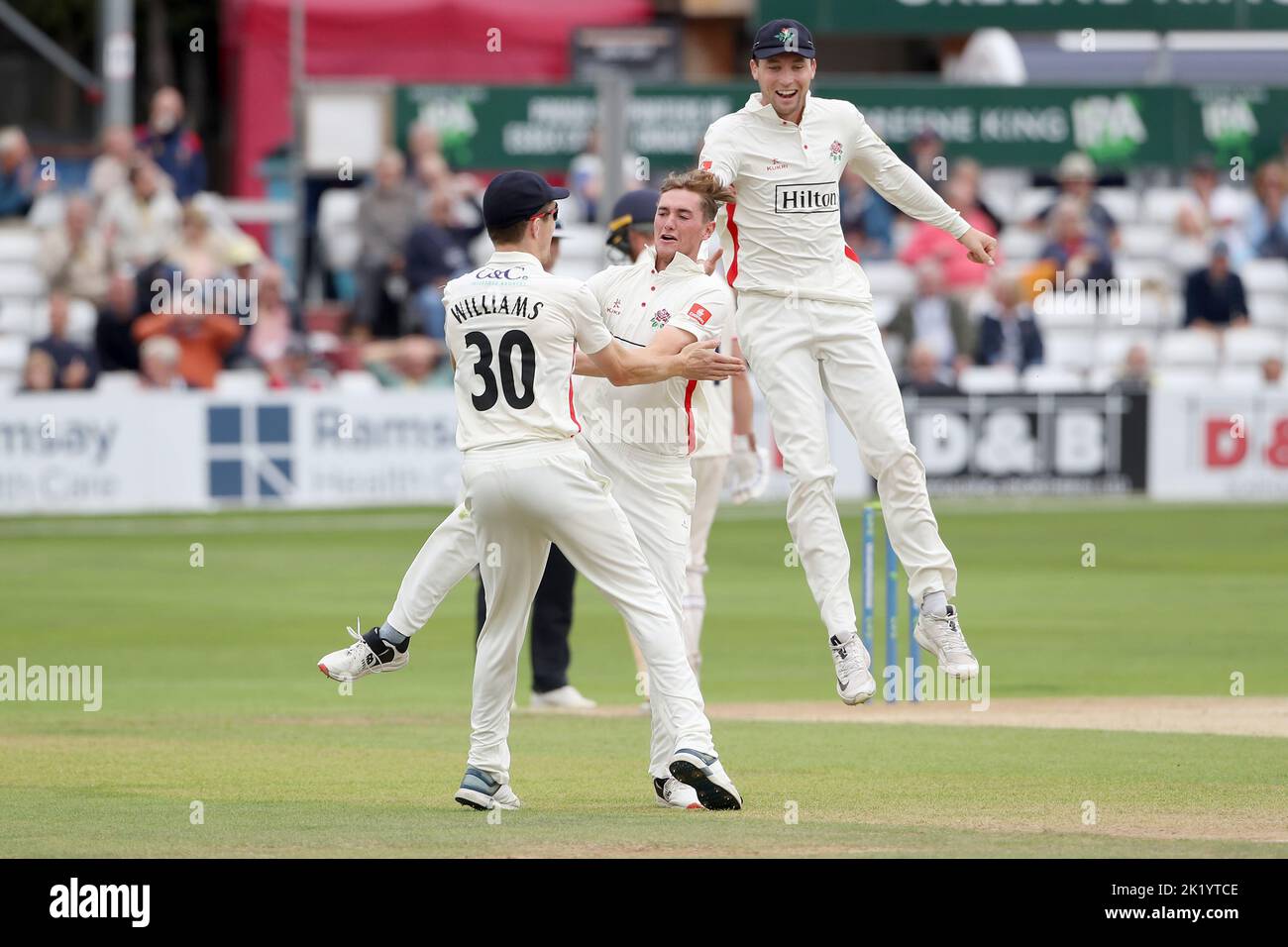 George Balderson of Lancashire celebrates with his team mates after taking the wicket of Matt Critchley to complete his hat-trick during Essex CCC vs Stock Photo