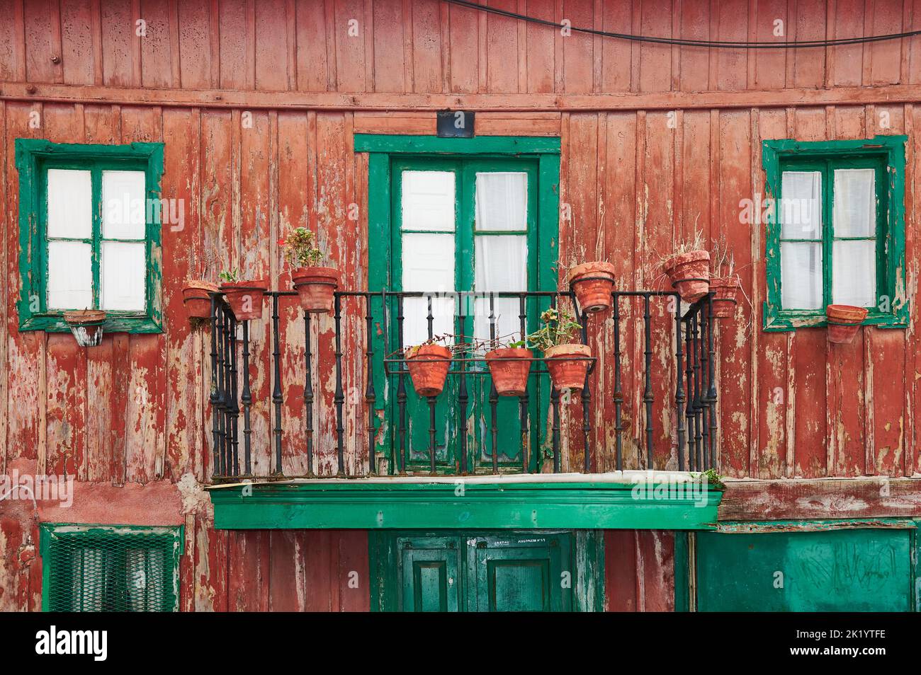 Detail of ancient wooden house in red and green colors Stock Photo