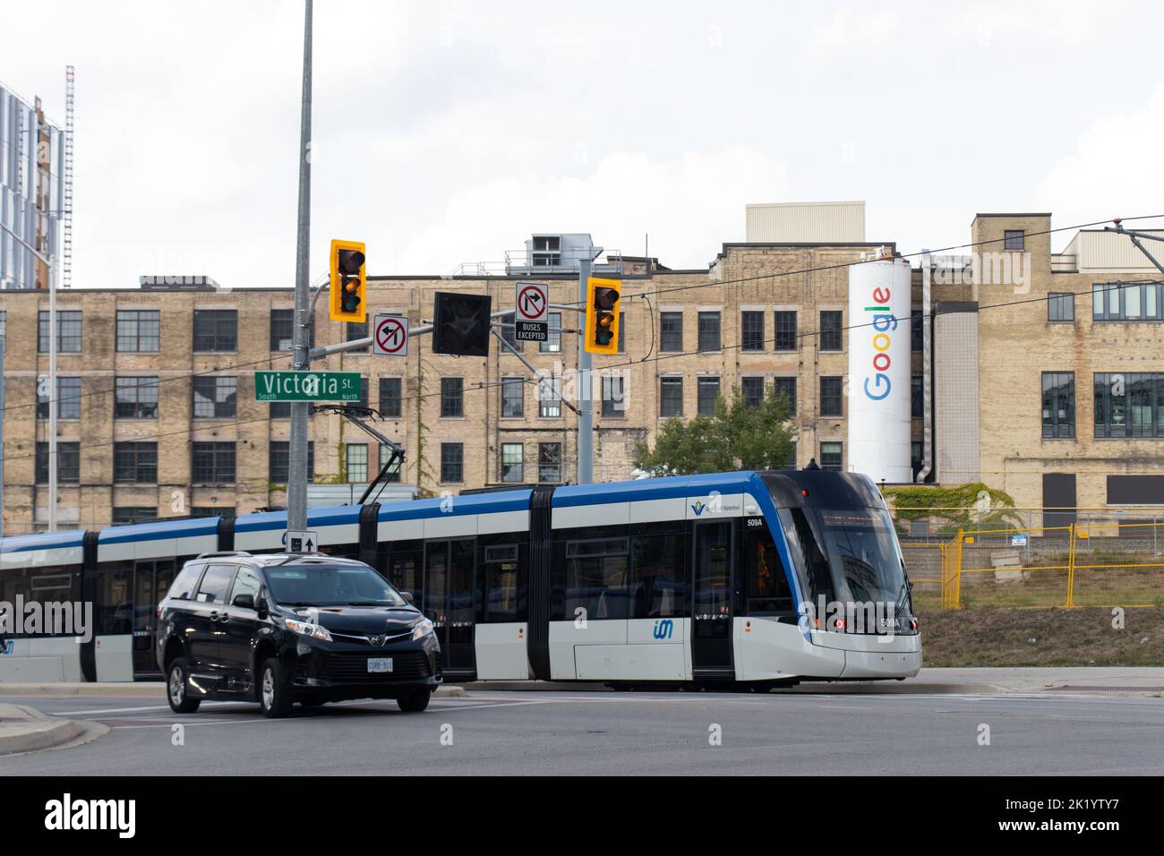 A Waterloo Region, Grand River Transit Alstom, formally Bombardier streetcar is seen in downtown Kitchener passing by a Google office in background. Stock Photo