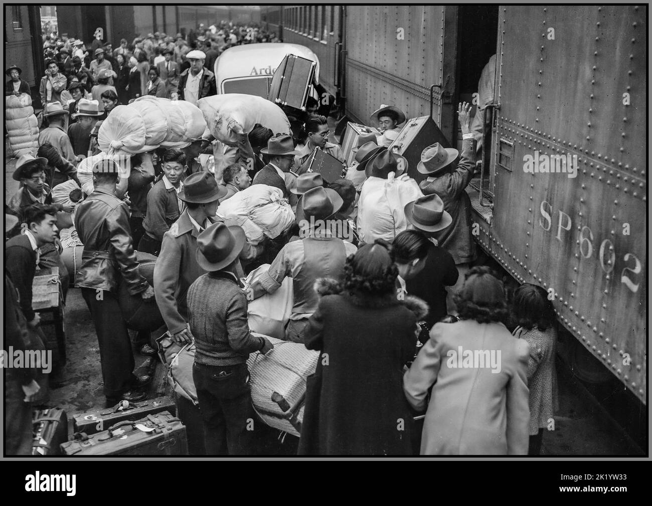 WW2 Japanese residents in the USA being relocated during WW2 Los Angeles, California. Evacuees of Japanese ancestry boarding a train for Manzanar, California, 250 miles away, where they will  now be housed in a War Relocation Authority center. Date between 1942 and 1945 Stock Photo