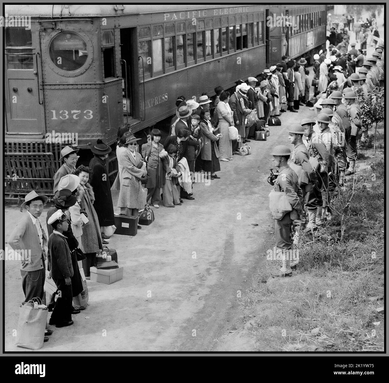 WW2 Japanese citizens evacuees in the USA Arcadia, California. Propaganda image of persons of Japanese ancestry arrive at the Santa Anita Assembly center from San Pedro, California. Evacuees lived at this center at the Santa Anita race track before being moved inland to relocation centers. Date5 April 1942 Stock Photo