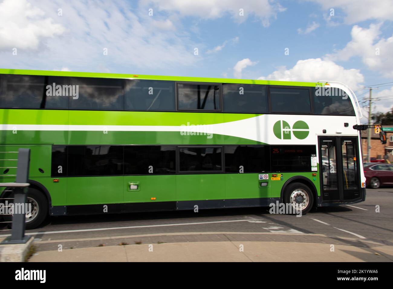 A GO bus, owned by the Government of Ontario and a main transit provider throughout Ontario is seen in motion in a downtown area. Stock Photo