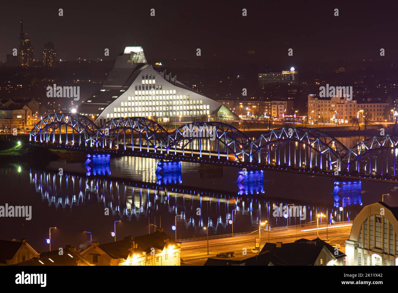 Scenic Riga Scenic night top view of Riga, with a train crossing the bridge near ...