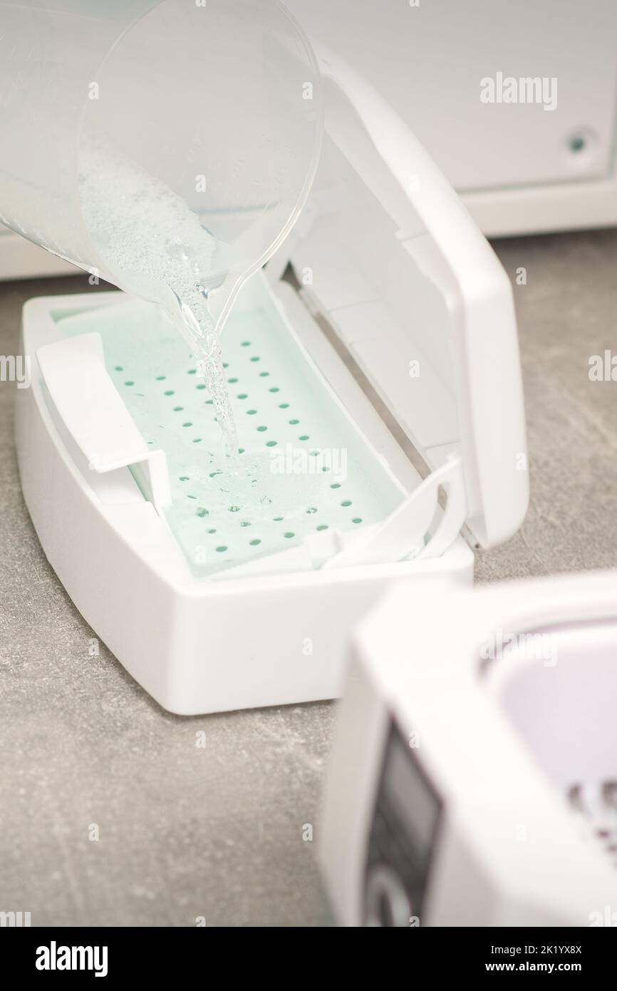 Adding liquid for disinfection of instruments to the machine for