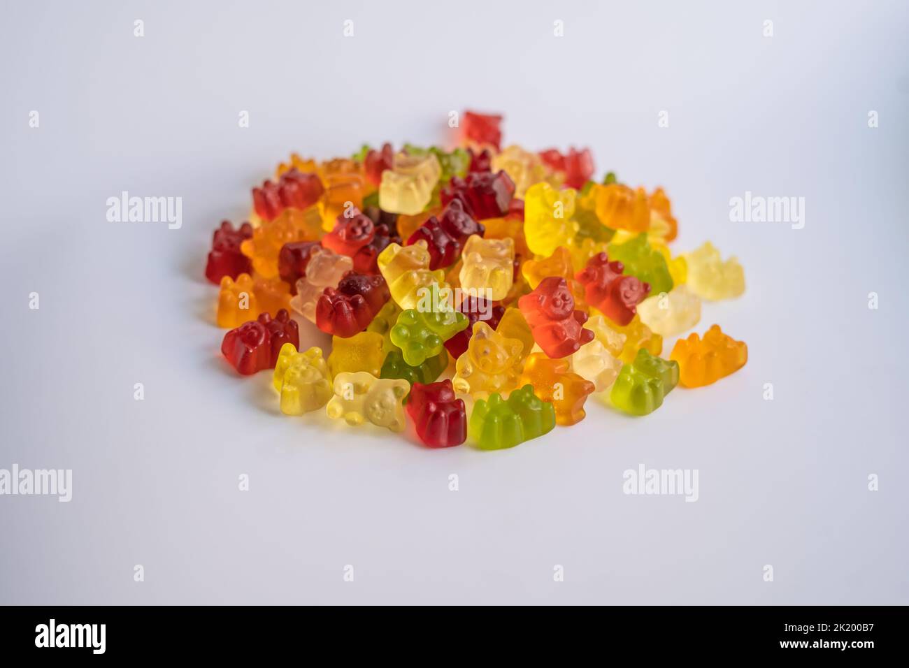 a bunch of colorful gummy bears on a white background front view Stock Photo