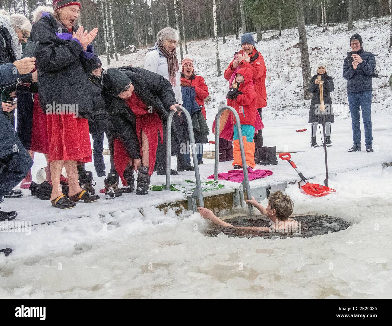 Woman swimmning in winter. Cold water, snow an people. photo: bo arrhed Stock Photo