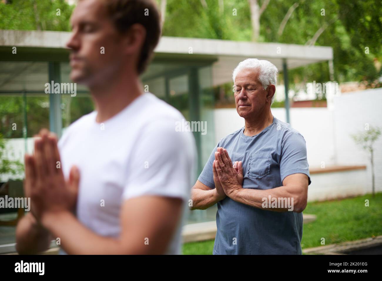 Making some time to clear the mind. a senior man meditating in an outdoor yoga class. Stock Photo