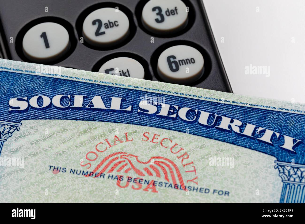 Social security card and telephone. Fraud, scam and identity theft concept. Stock Photo