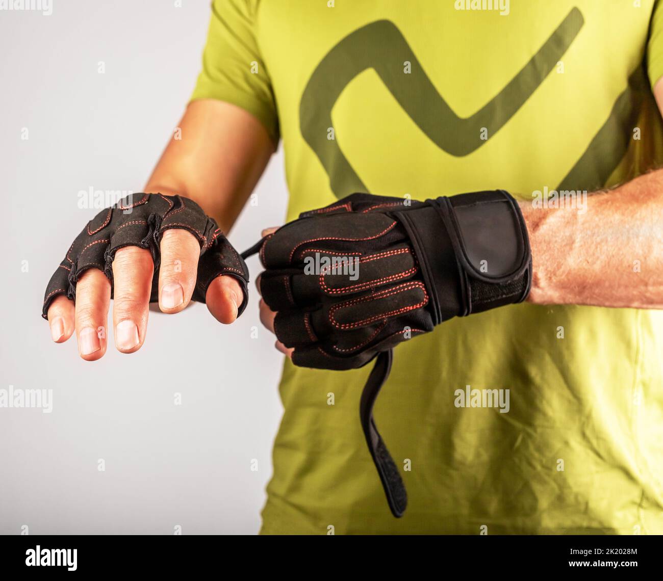 Wearing, putting on sport workout gloves close up for palm and wrist