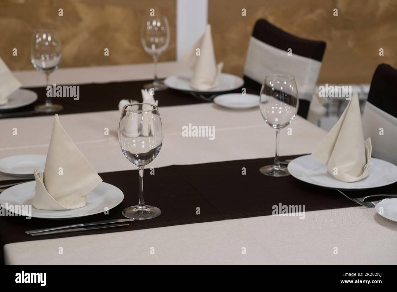 Banquet table with wineglasses. High angle of elegant banquet table served for wedding celebration. Stock Photo