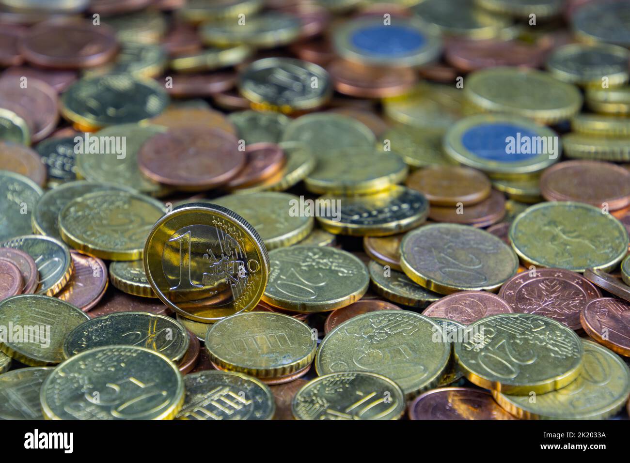 Many euro coins for financial background with focus on 1 euro coin Stock Photo