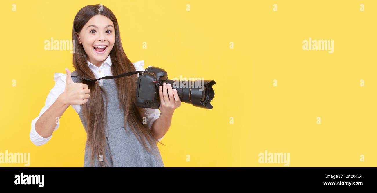 happy teen girl photographer use digital photo camera show thumb up