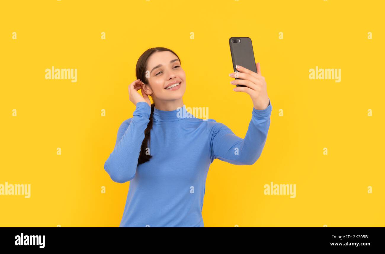 cheerful lady making selfie photo on mobile phone, video Stock Photo