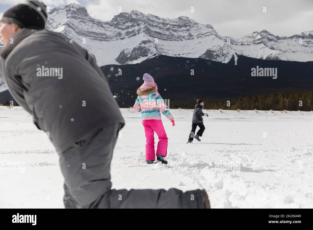 Brothers and sister playing in snow Stock Photo - Alamy