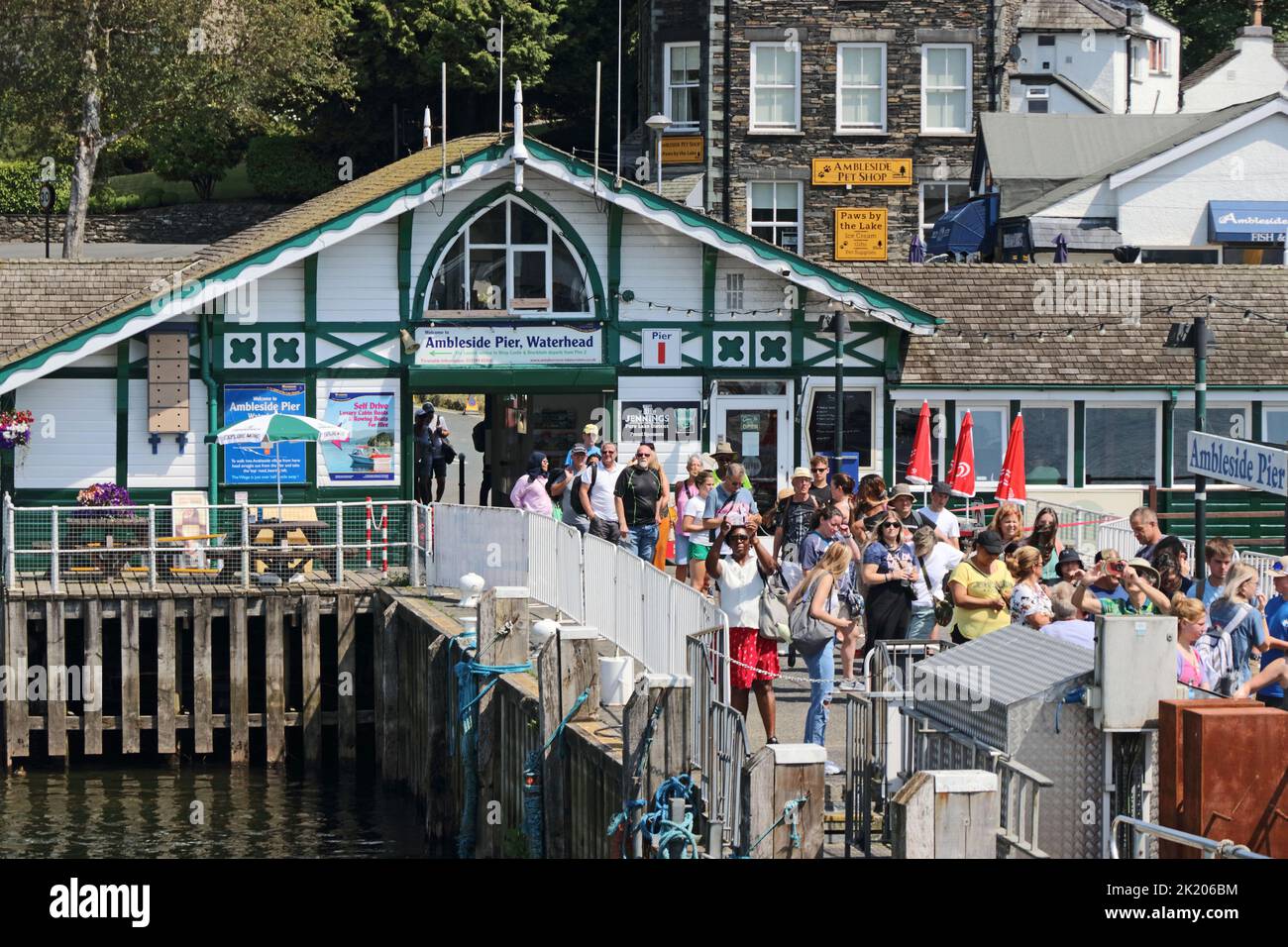 Tourists queue for boats, Ambleside Pier, Waterhead, Lake Windermere Stock Photo