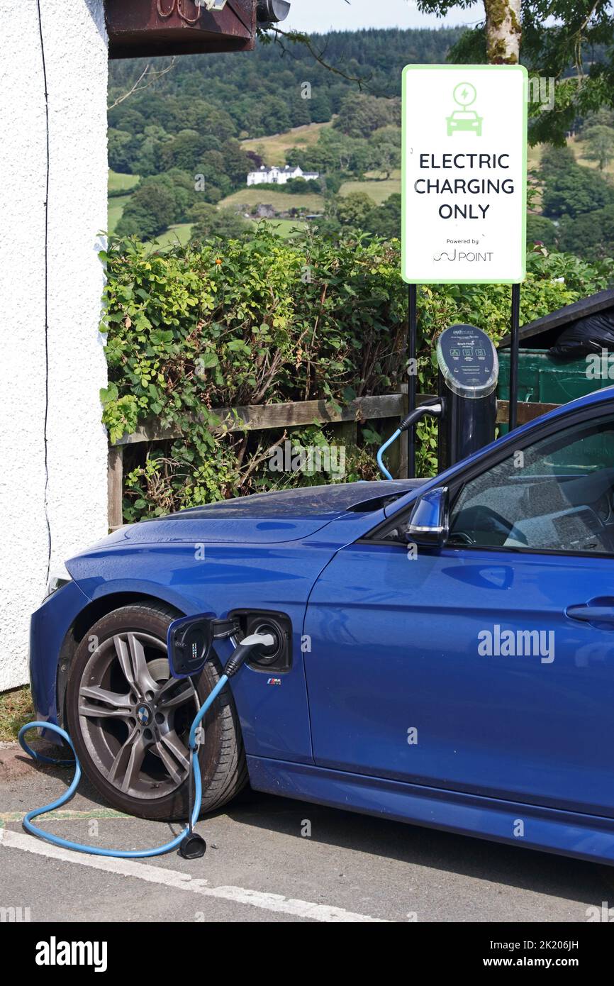 Blue BMW hybrid saloon car charging batteries Stock Photo