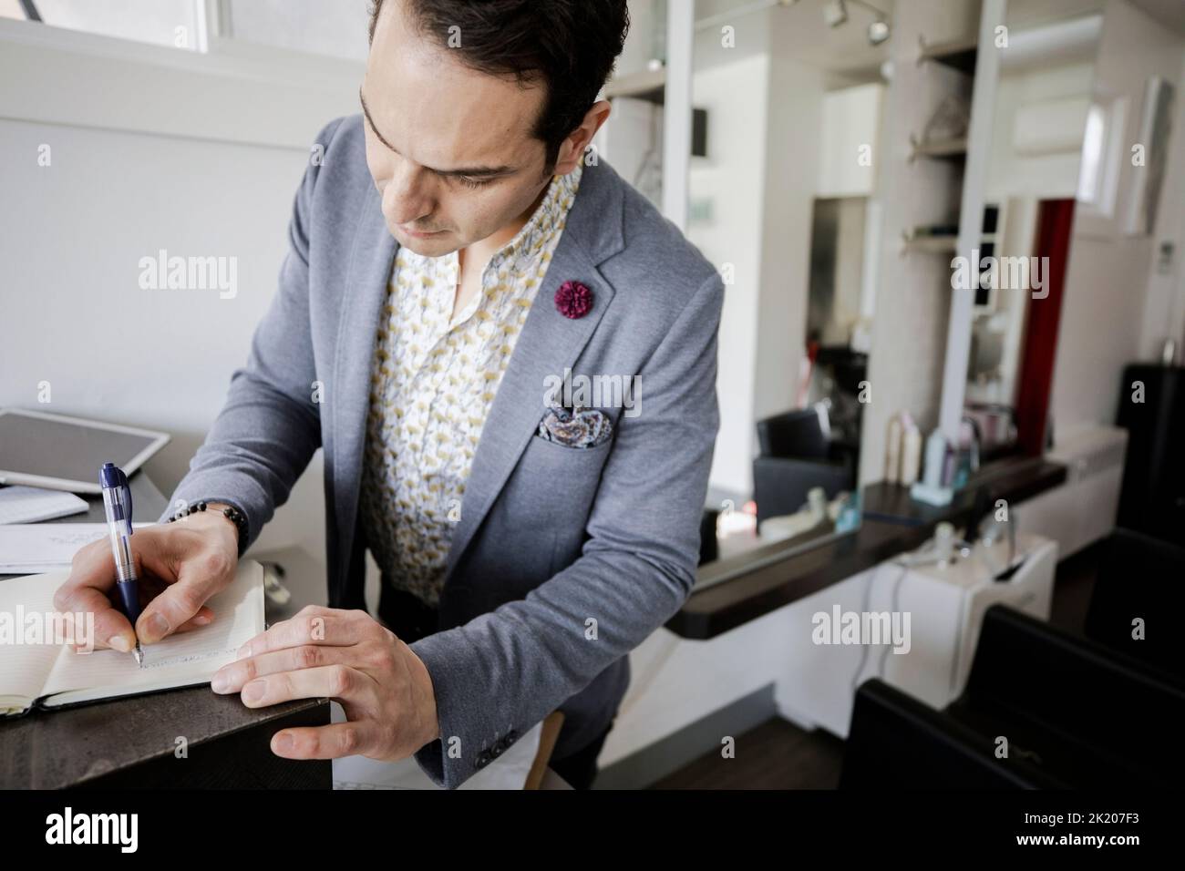 business owner taking notes in hair salon Stock Photo - Alamy
