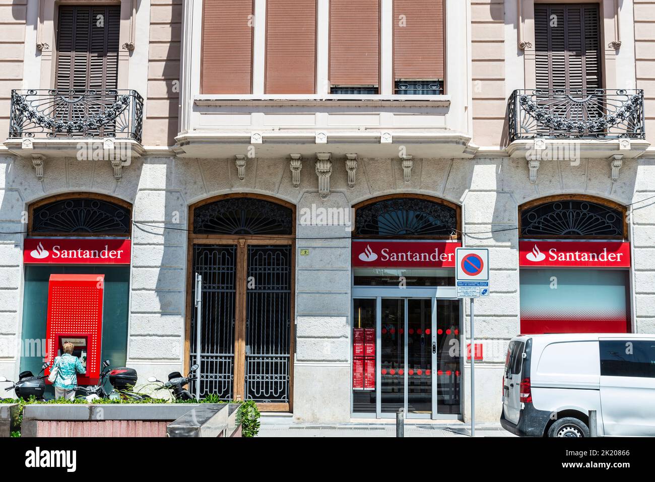 Tortosa, Spain - May 13, 2022: Facade and logo of the Banco Santander with people at the ATM in Tortosa, Catalonia, Spain Stock Photo